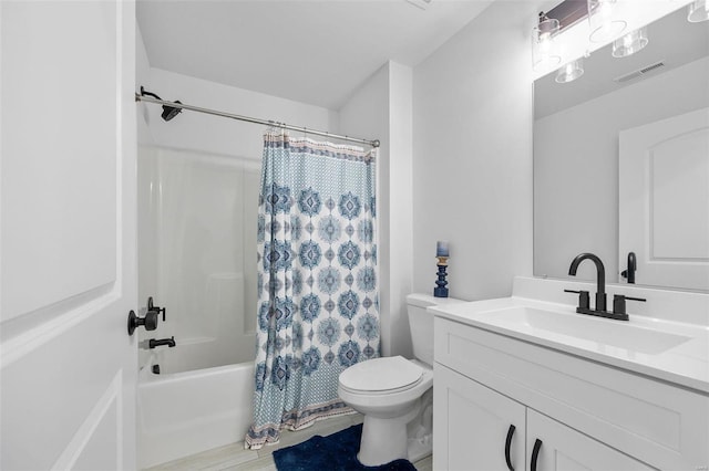 full bathroom with vanity, shower / tub combo, and toilet