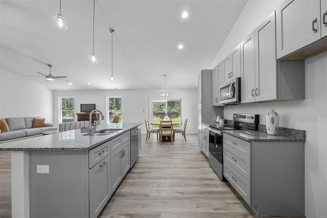 kitchen featuring appliances with stainless steel finishes, sink, pendant lighting, and gray cabinetry