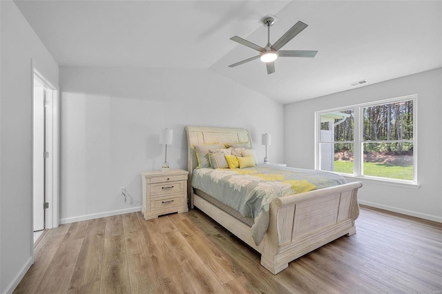 bedroom with ceiling fan, lofted ceiling, and light hardwood / wood-style floors