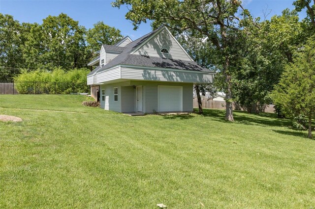 view of home's exterior featuring a garage and a lawn