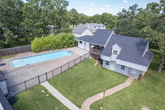 view of pool featuring a lawn