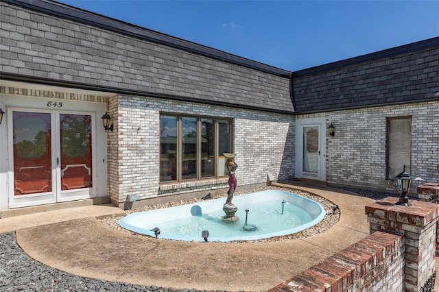 view of pool featuring french doors