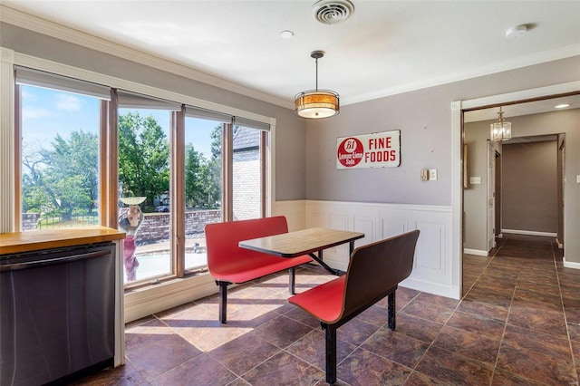 tiled dining room with ornamental molding and a wealth of natural light