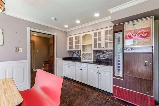 kitchen featuring ornamental molding, decorative backsplash, and white cabinets