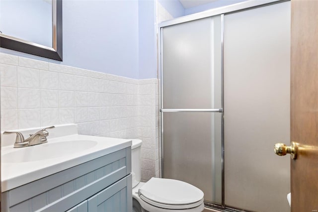 bathroom with vanity, tile walls, an enclosed shower, and toilet