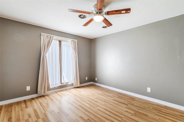 empty room featuring ceiling fan and light hardwood / wood-style floors