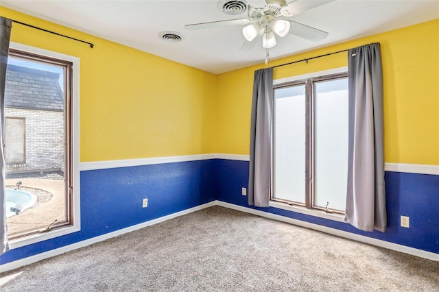 spare room with ceiling fan and carpet flooring