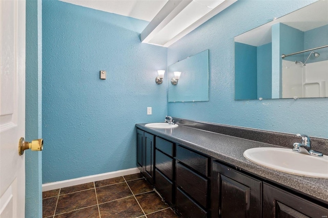 bathroom with double sink vanity and tile patterned flooring