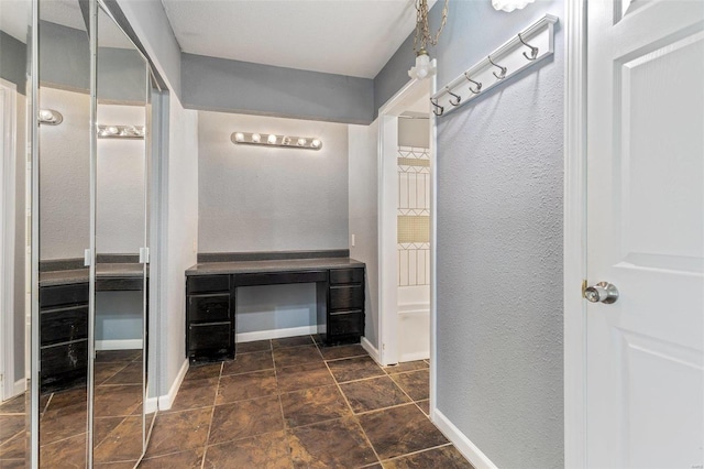 mudroom featuring dark tile patterned flooring