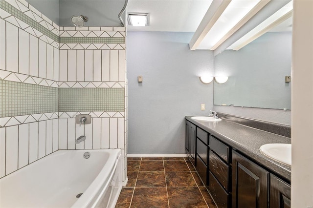 bathroom featuring tiled shower / bath and vanity