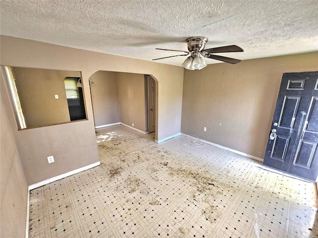 unfurnished room featuring a textured ceiling and ceiling fan