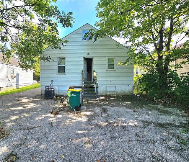 rear view of house with entry steps and central air condition unit