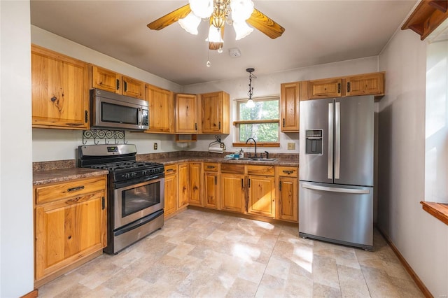 kitchen with ceiling fan, appliances with stainless steel finishes, pendant lighting, and sink