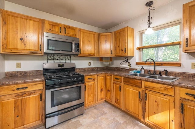 kitchen with stainless steel appliances, hanging light fixtures, and sink