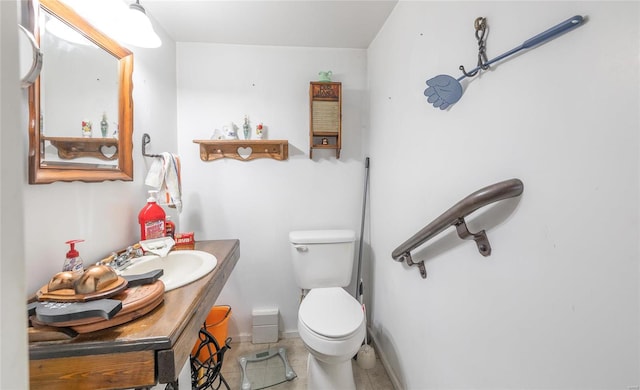 bathroom featuring toilet, vanity, and tile patterned floors