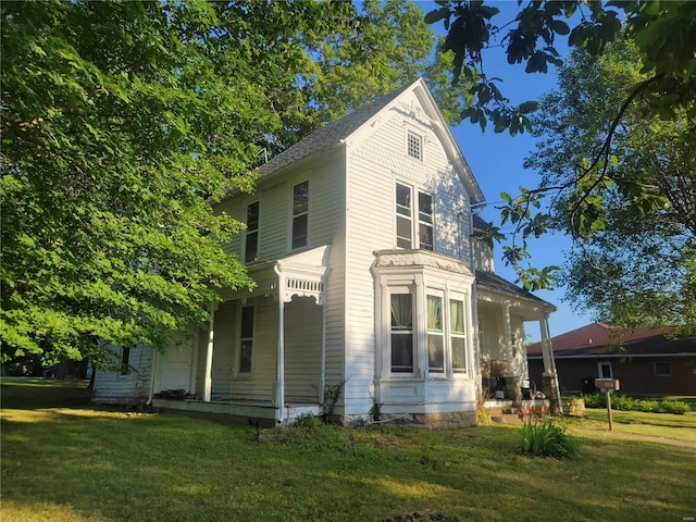 exterior space with a porch and a lawn