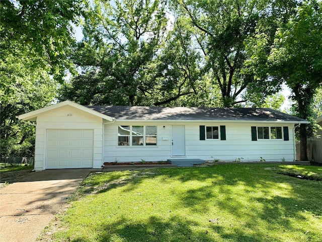 ranch-style house featuring a garage and a front yard