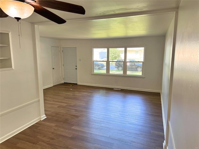 spare room with dark hardwood / wood-style floors and ceiling fan