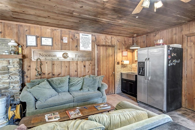 living room featuring ceiling fan, wooden walls, and wood ceiling