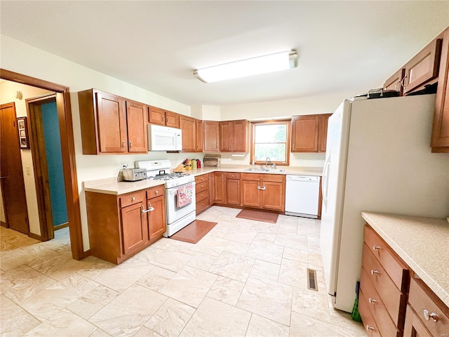 kitchen with sink and white appliances