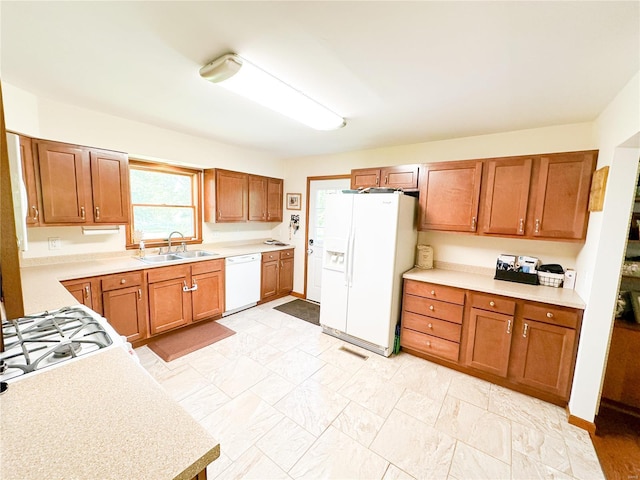 kitchen with white appliances and sink