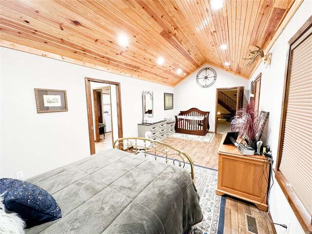 bedroom featuring vaulted ceiling, light hardwood / wood-style flooring, and wooden ceiling