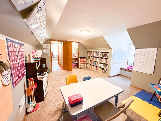 playroom with light colored carpet and vaulted ceiling