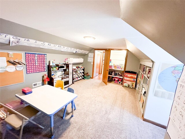 recreation room with carpet and vaulted ceiling