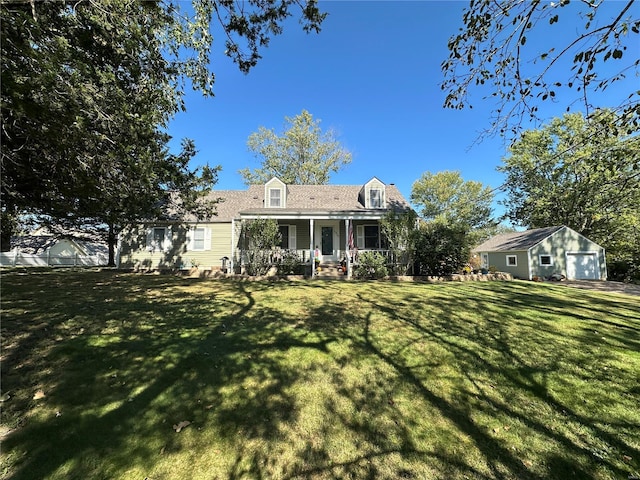 rear view of property featuring an outdoor structure, a porch, a garage, and a yard