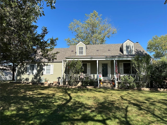 new england style home featuring covered porch and a front yard