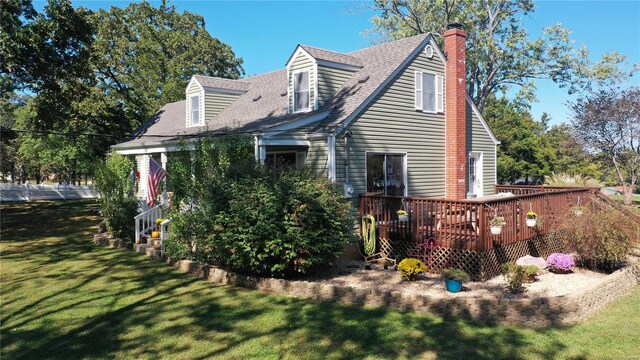 rear view of house featuring a yard and a wooden deck