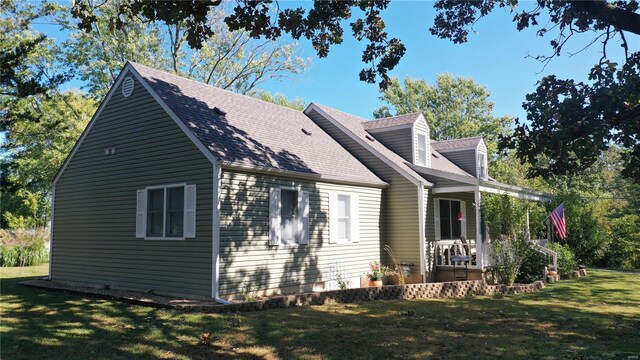 exterior space featuring a porch and a yard