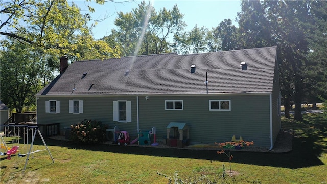 rear view of property featuring a lawn