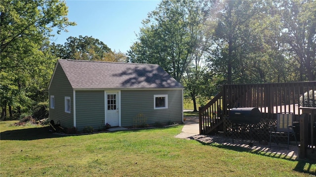 rear view of property with a yard and a deck