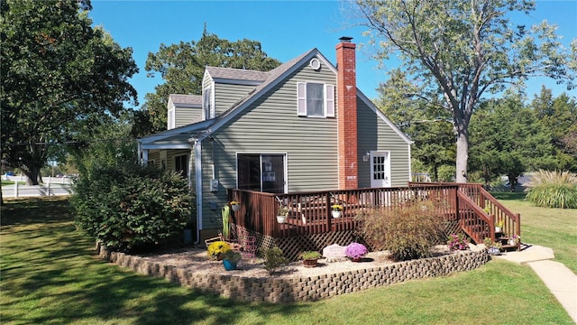 rear view of house with a yard and a wooden deck