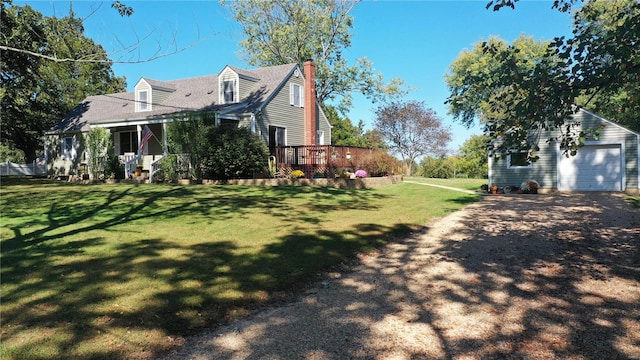 view of side of home with a garage, an outbuilding, a yard, and a wooden deck