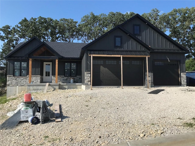 modern inspired farmhouse featuring board and batten siding, stone siding, roof with shingles, and driveway