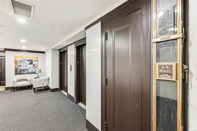 hallway featuring dark colored carpet and crown molding