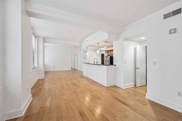 unfurnished living room with light hardwood / wood-style floors