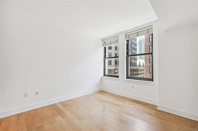 empty room with light hardwood / wood-style floors