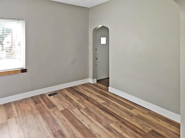 spare room with hardwood / wood-style floors