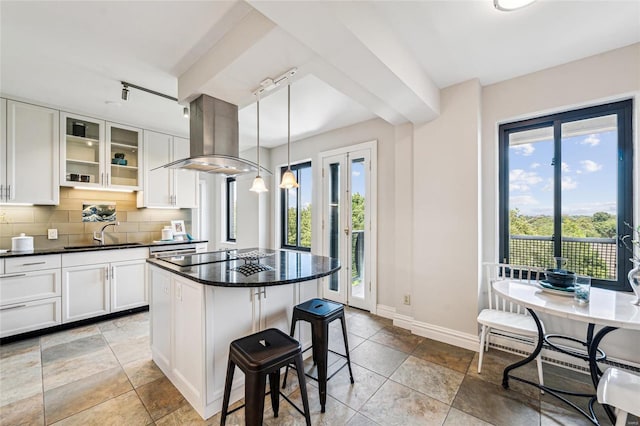 kitchen with island exhaust hood, a kitchen island, pendant lighting, and white cabinets