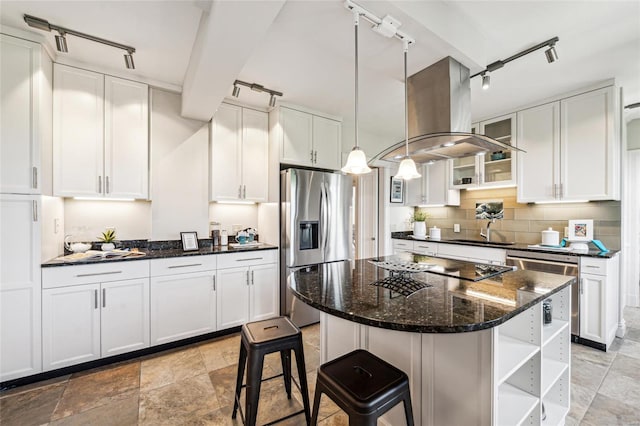 kitchen featuring island range hood, appliances with stainless steel finishes, pendant lighting, and white cabinets