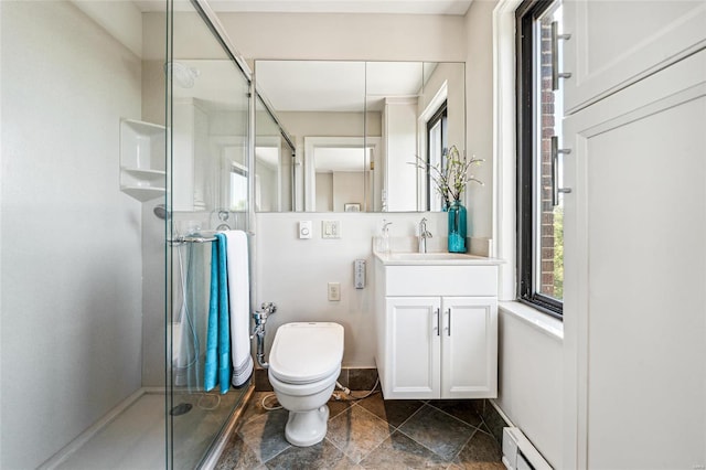 bathroom featuring vanity, toilet, and a shower with door