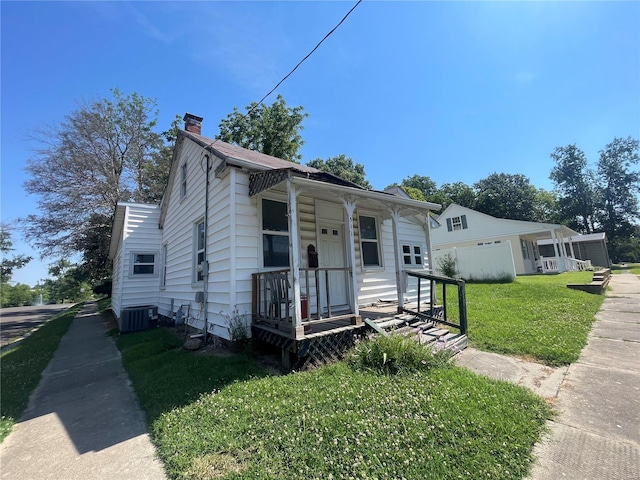 bungalow-style house with central AC, a porch, and a front yard