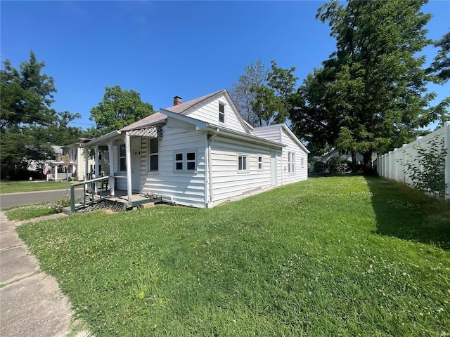 view of side of home with a lawn