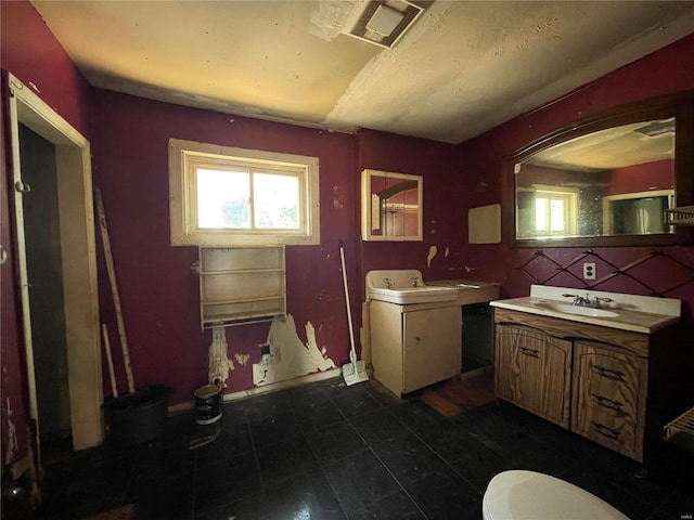 bathroom with backsplash, vanity, and toilet