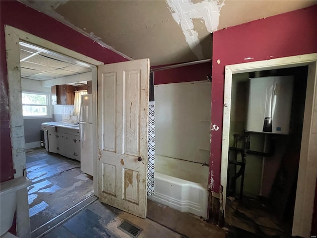 full bathroom featuring vanity,  shower combination, toilet, and water heater