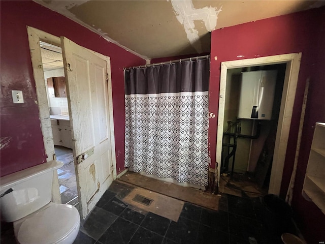 bathroom featuring curtained shower, water heater, and toilet