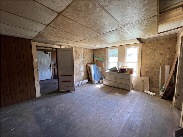 interior space with hardwood / wood-style floors and a drop ceiling